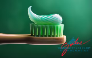 toothbrush with a green toothpaste on